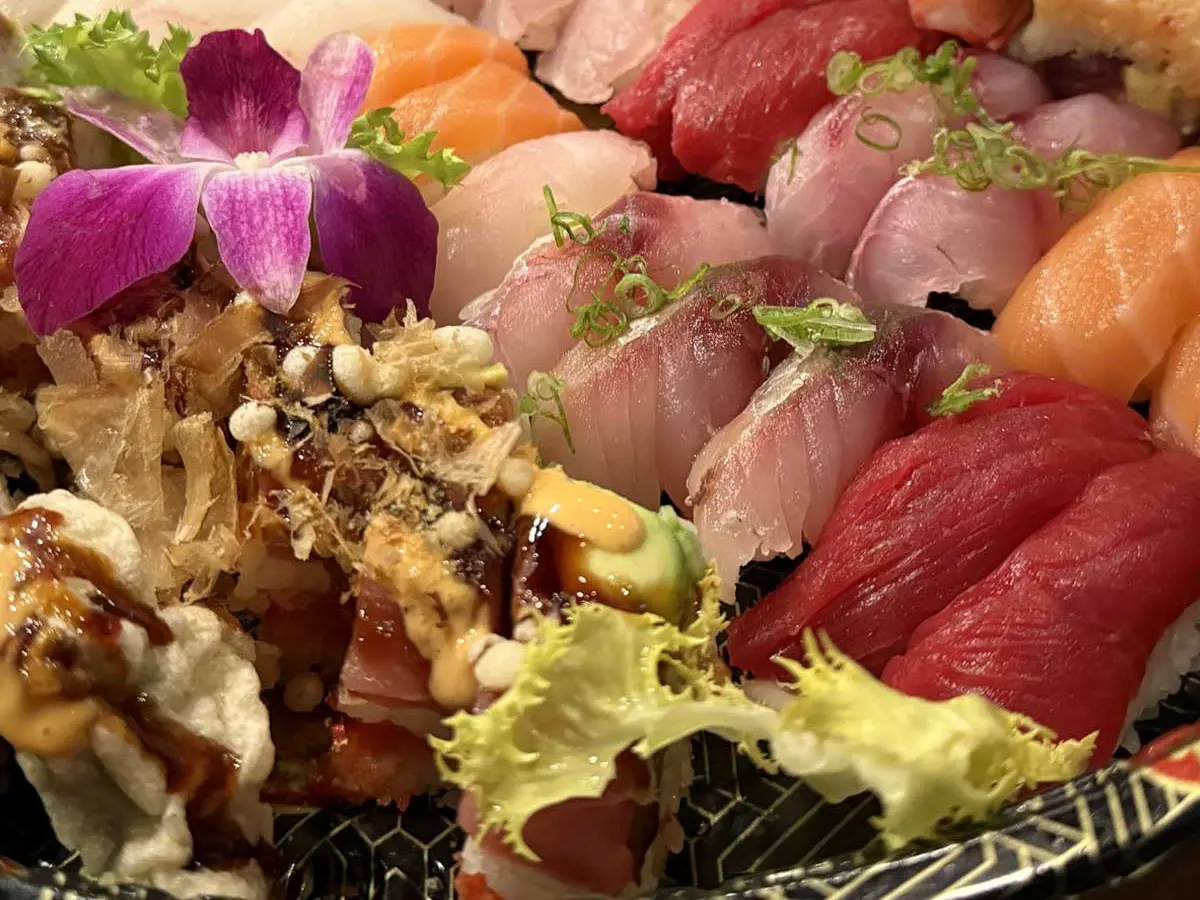 Nigiri spread of tuna, salmon, yellowtail and white fish w/an orchid garnish